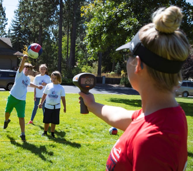 Students measuring the speed of a volleyball serve, as led by STEM Sports partner Skyhawks Sports during an after-school program.