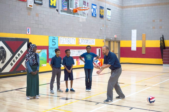 Jeff Golner, CEO of STEM Sports, a Phoenix business that provides standards-aligned K-8 supplemental curricula that enhance students' STEM skills with sports as real-life applications, participates in a volleyball STEM lesson with students from Crockett Elementary School in the Balsz School District.