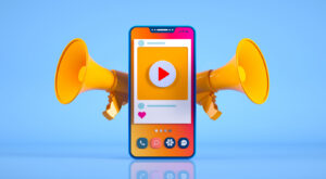 A cellphone opened to a video app propped up with two megaphones behind it