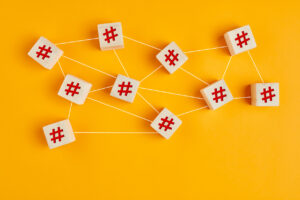 Wooden blocks with hashtag symbols spread out and connected by white threads