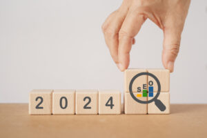 Wooden blocks stacked to spell out 2024 and show a magnifying glass with SEO inside